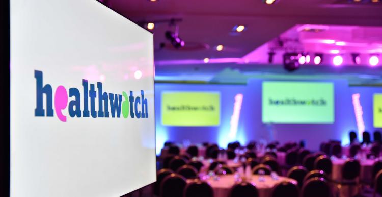 A screen at the Healthwatch awards ceremony in 2019 with the Healthwatch logo displayed