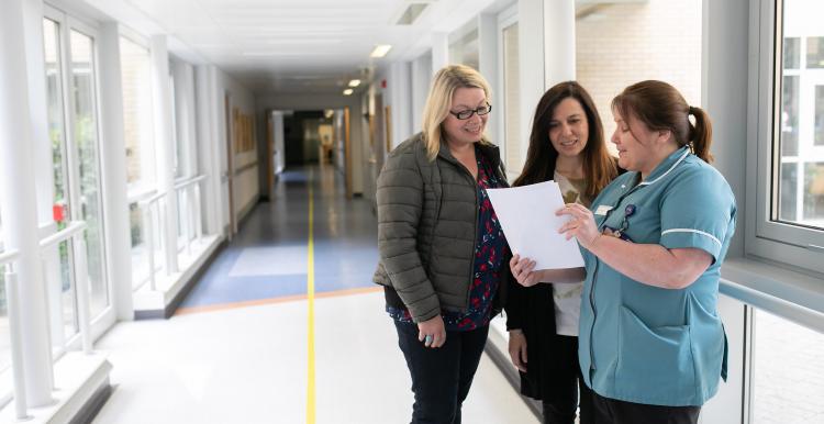 Family members speaking to a hospital worker