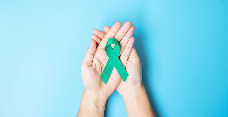 Ovarian Cancer Awareness month ribbon held in a pair of hands