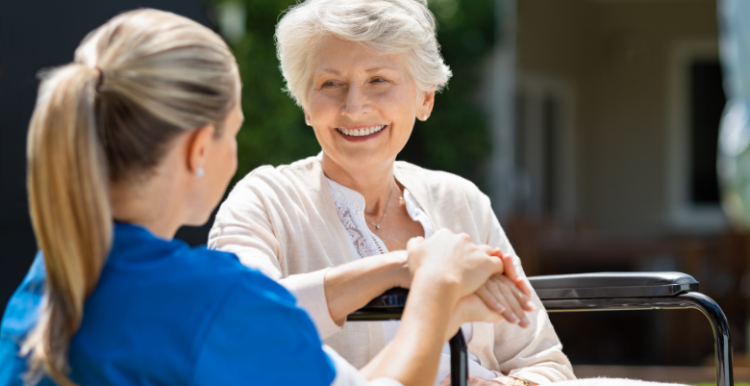 A woman helping a woman in a wheelchair