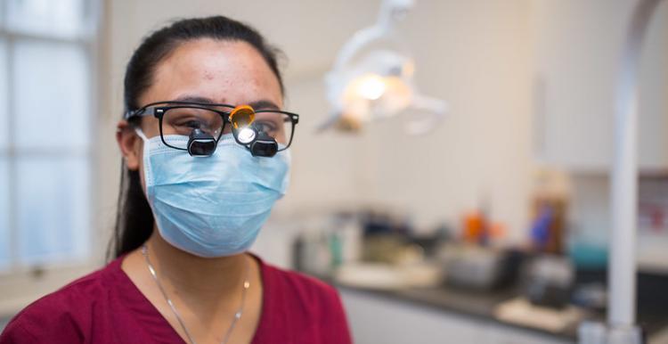 Female dentist wearing a mask