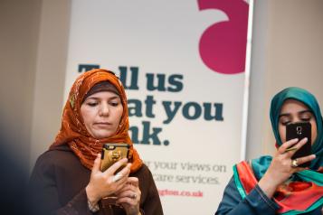 Two women looking at their mobile phones