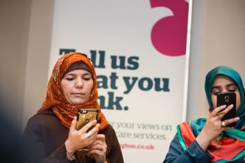Two women looking at their mobile phones