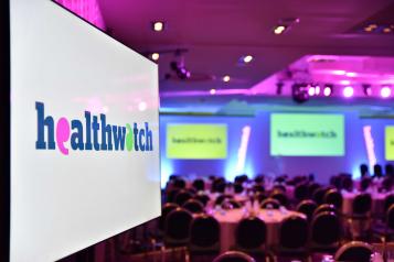 A screen at the Healthwatch awards ceremony in 2019 with the Healthwatch logo displayed