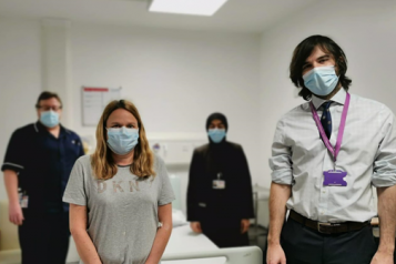 Four people wearing face masks inside the hospital