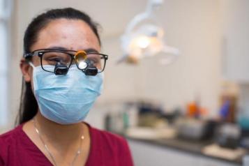 Female dentist wearing a mask