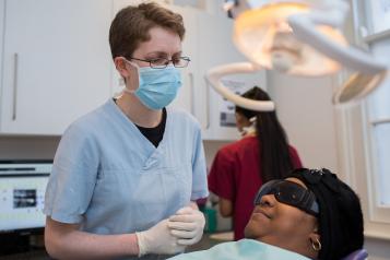 A dentist with a patient in the dentist chair