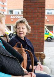 Two_Women_Sitting_Outside_Hosptial_Entrance